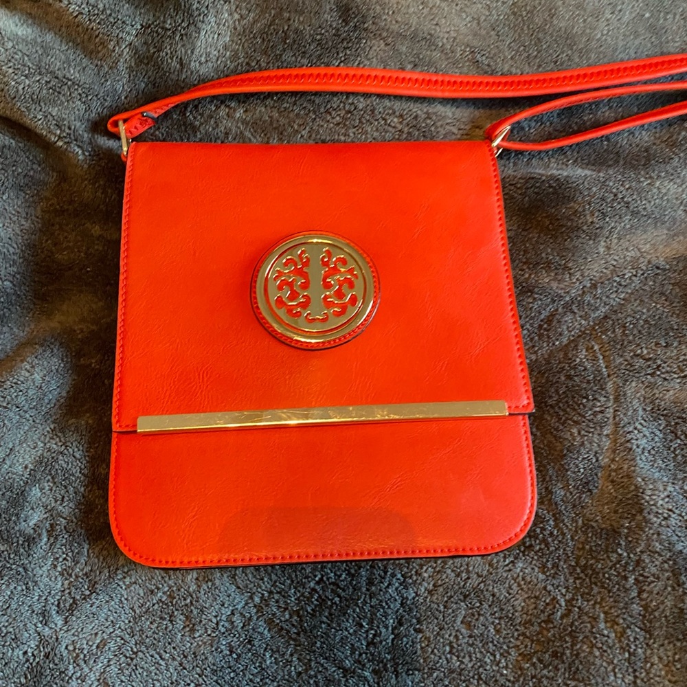 Beautiful orange Crossbody bag with gold accents